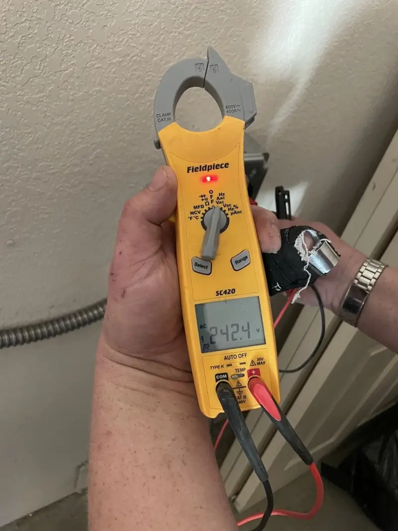 Voltage testing with clamp meter during Outlet Installation in Triangle
